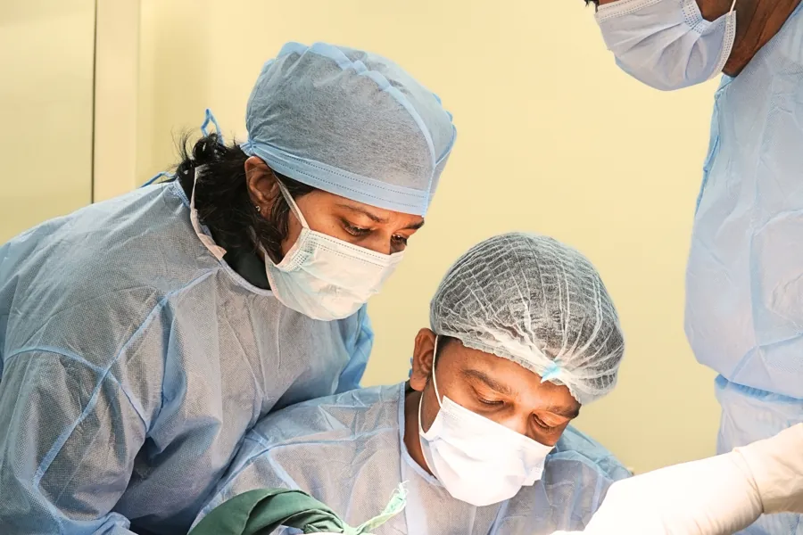 Clinicians carrying out a supervised procedure at a training course